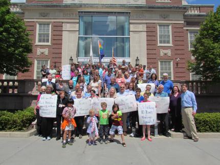 FUSN members celebrate the 10th anniversary of equal marriage on the Newton Court House steps. Photo: Eileen Kurkoski. FUSN members celebrate the 10th anniversary of equal marriage on the Newton Court House steps. Photo: Eileen Kurkoski.